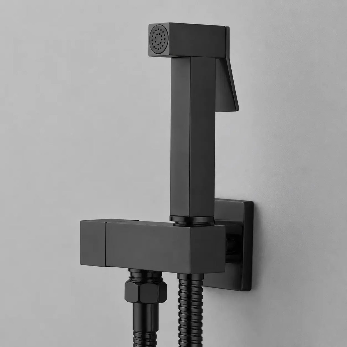 Douchette hygiénique WC noir mat avec gâchette ergonomique, design carré mural moderne et flexible discret.