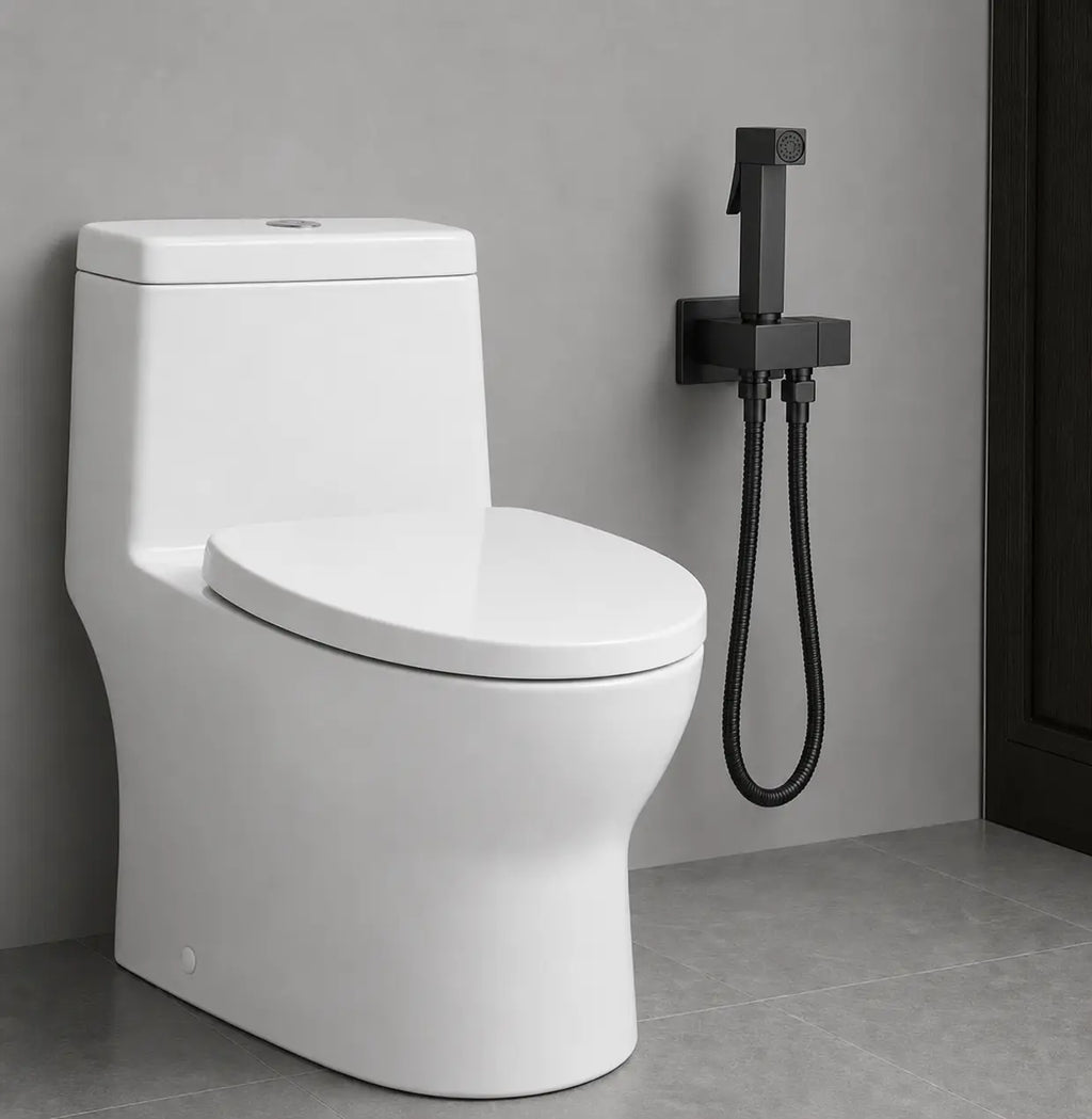 Douchette WC noir mat installée près des toilettes, avec support mural discret et flexible assorti au design moderne.