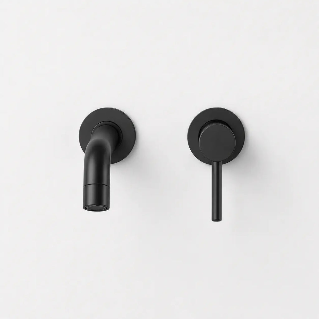 Robinet mural noir mat avec bec court arrondi et commande minimaliste pour lavabo moderne et élégant.